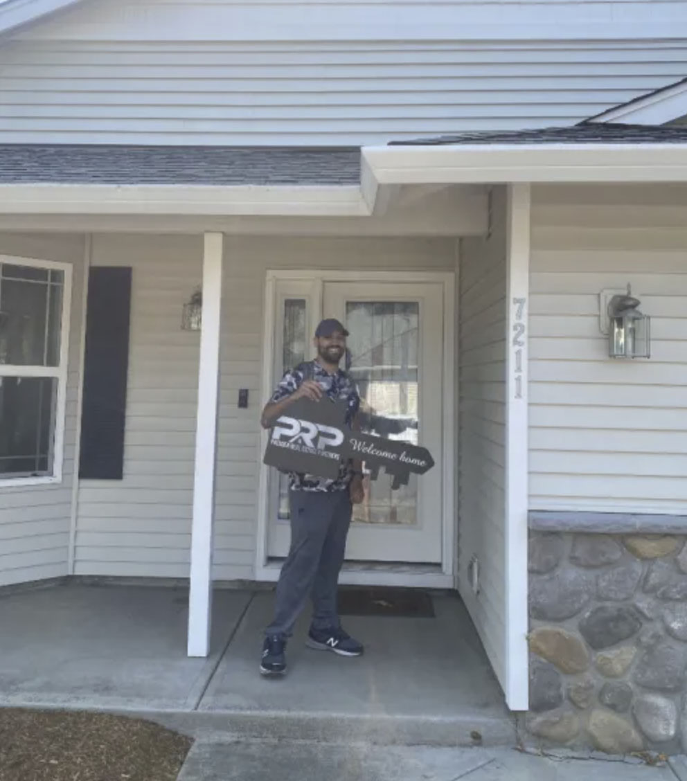 picture of Brandon G. in front of a house